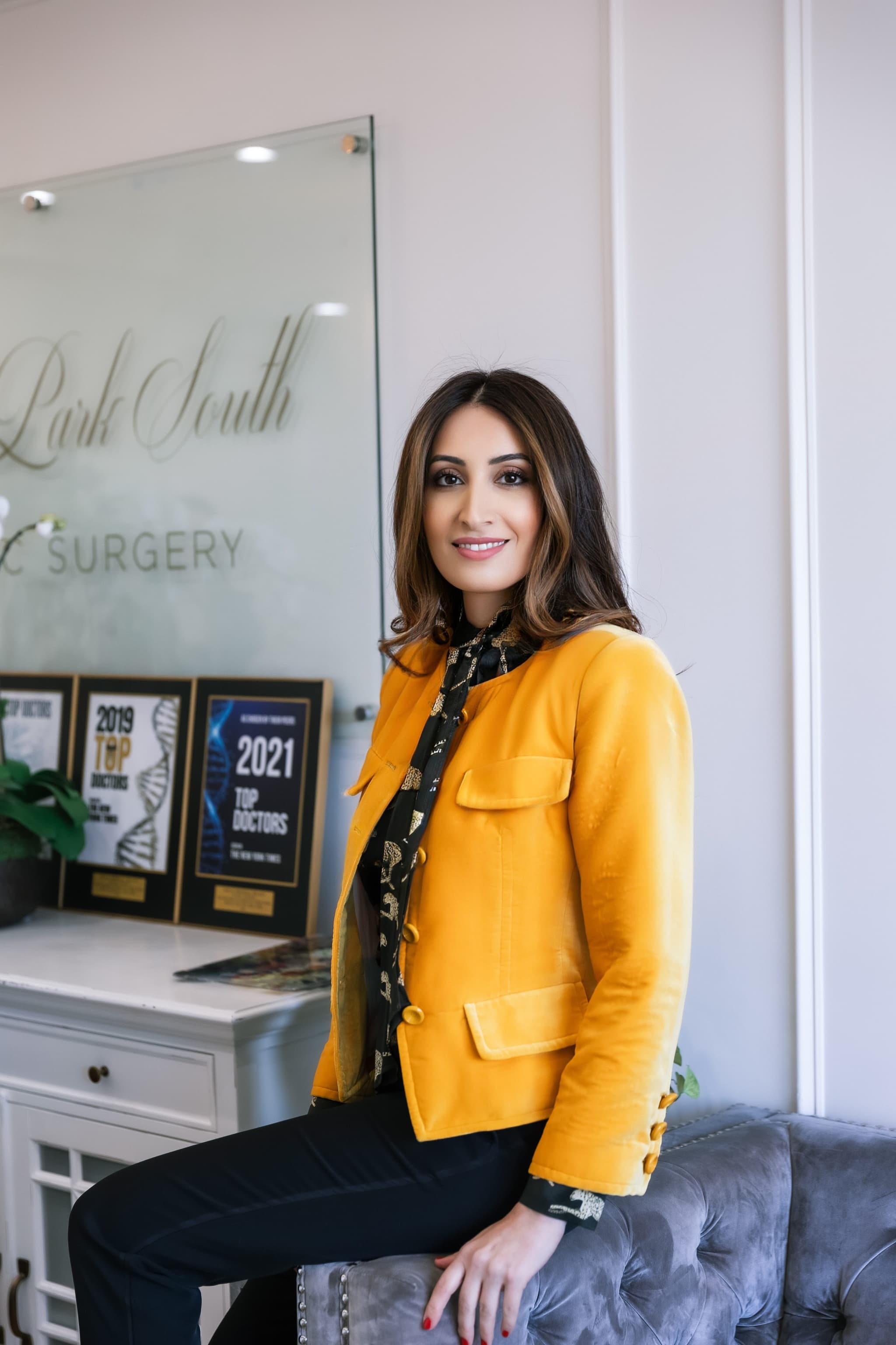 Dr. Dana Khuthaila in her New York City office, beside her Top Doctors awards